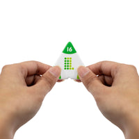 Triangle-shaped die with number 16 held between two hands on a white background