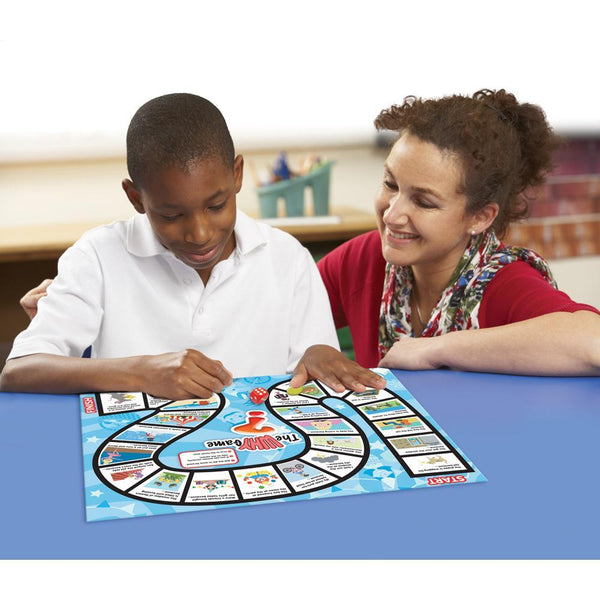 teacher and boy playing Junior Learning JL406 the why board game